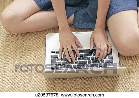 Stock Photo - Young Woman Typing with Laptop. Fotosearch
