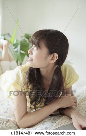Young Woman Using Laptop and Looking Up View Large Photo Image Stock Photo - Young Woman Using Laptop and Looking Up. Fotosearch