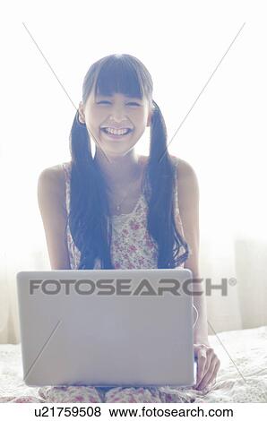 Stock Photo - Young Woman Using Laptop. Fotosearch