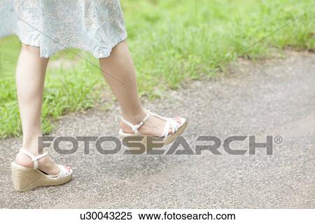 Young Woman Walking, Focus on Feet View Large Photo Image Stock Photography - Young Woman Walking, Focus on Feet. Fotosearch