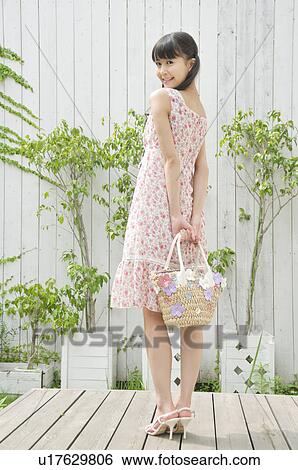 Young Woman Wearing Floral Dress View Large Photo Image Stock Photograph - Young Woman Wearing Floral Dress. Fotosearch