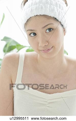 Stock Image - Young Woman Wearing Headband. Fotosearch