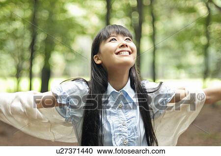 Stock Image - Young Woman with Arms Outstretched. Fotosearch