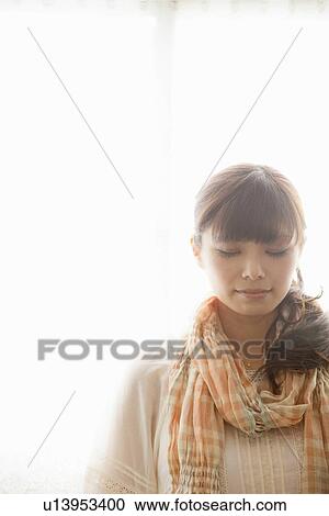 Stock Image - Young Woman with Eyes Closed. Fotosearch