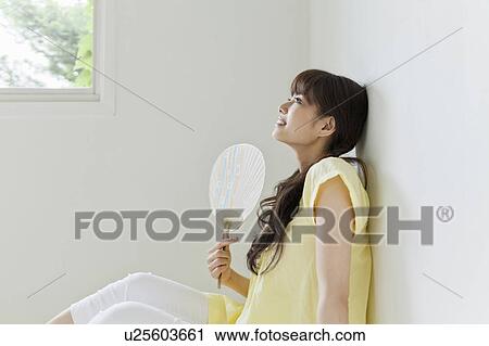 Stock Image - Young Woman with Fan. Fotosearch