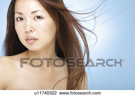 Stock Image - Young woman with hair flowing. Fotosearch