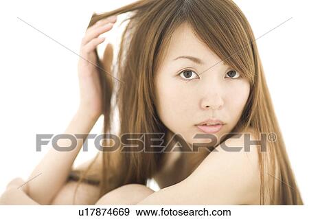 Young woman with hand in hair View Large Photo Image Stock Photo - Young woman with hand in hair. Fotosearch