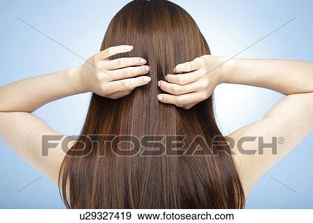 Young woman with hand in hair View Large Photo Image Stock Photo - Young woman with hand in hair. Fotosearch