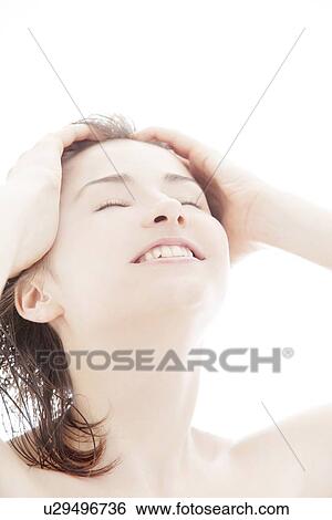 Young woman with hand in hair View Large Photo Image Stock Photograph - Young woman with hand in hair. Fotosearch