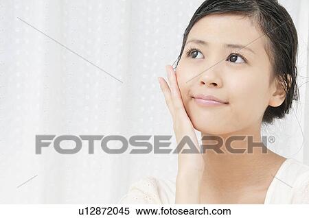 Stock Photography - Young Woman with Hand on Cheek. Fotosearch