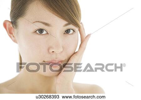 Young woman with hand on chin View Large Photo Image Stock Image - Young woman with hand on chin. Fotosearch