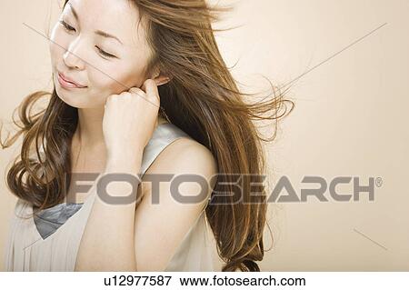 Young woman with hand on chin View Large Photo Image Stock Photo - Young woman with hand on chin. Fotosearch