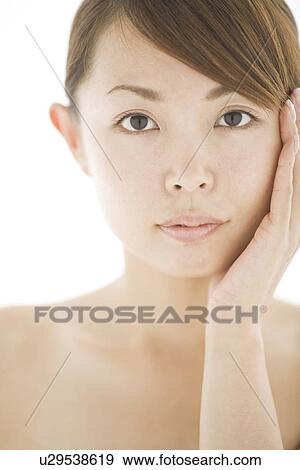 Young woman with hand on chin View Large Photo Image Stock Photo - Young woman with hand on chin. Fotosearch