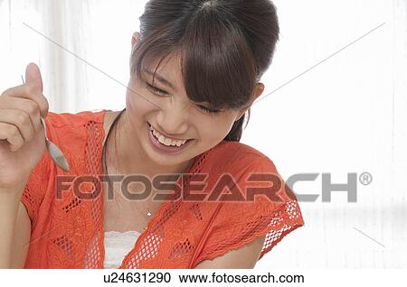 Stock Image - Young Woman with Spoon. Fotosearch
