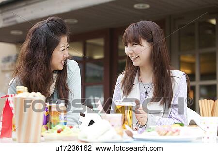 Young women drinking beer outdoors View Large Photo Image Stock Image - Young women drinking beer outdoors. Fotosearch