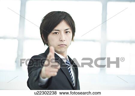 Stock Photo - A businessman pointing. Fotosearch
