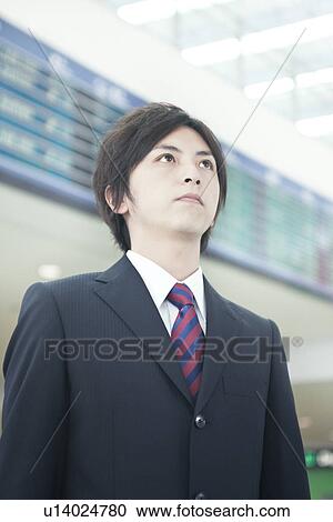 A businessman standing in front of electric bulletin board View Large Photo Image Stock Image - A businessman standing in front of electric bulletin board. Fotosearch