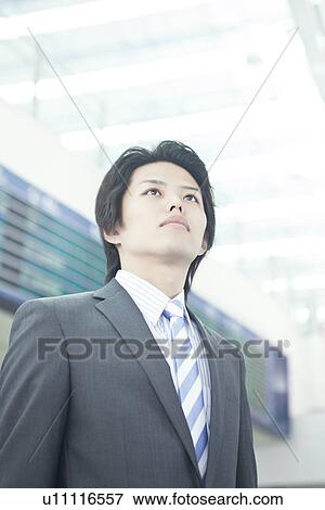 A businessman standing in front of electric bulletin board View Large Photo Image Stock Photo - A businessman standing in front of electric bulletin board. Fotosearch