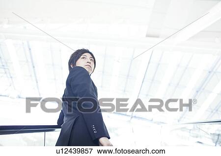 A businessman taking the escalator View Large Photo Image Stock Photo - A businessman taking the escalator. Fotosearch