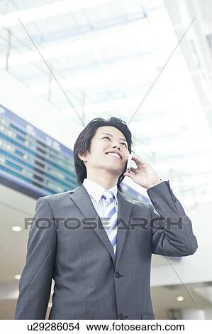 A businessman talking on the phone View Large Photo Image Picture - A businessman talking on the phone. Fotosearch
