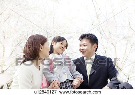 A family under cherry blossom trees View Large Photo Image Stock Photo - A family under cherry blossom trees. Fotosearch