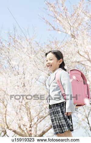 Stock Image - A girl carrying a school bag. Fotosearch