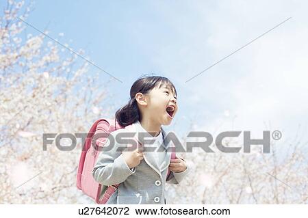 A girl carrying a school bag View Large Photo Image Stock Image - A girl carrying a school bag. Fotosearch