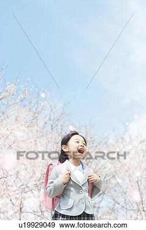 A girl carrying a school bag View Large Photo Image Stock Photo - A girl carrying a school bag. Fotosearch