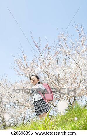 A girl carrying a school bag View Large Photo Image Stock Photography - A girl carrying a school bag. Fotosearch