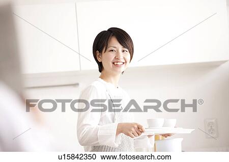 Stock Image - A woman carrying coffee. Fotosearch