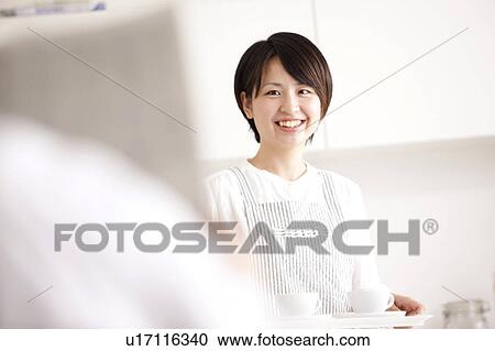 A woman carrying coffee View Large Photo Image Stock Image - A woman carrying coffee. Fotosearch