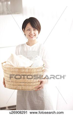 A woman carrying laundry View Large Photo Image Stock Image - A woman carrying laundry. Fotosearch