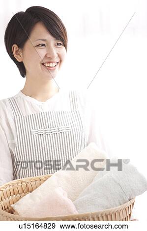 A woman carrying laundry View Large Photo Image Stock Photo - A woman carrying laundry. Fotosearch