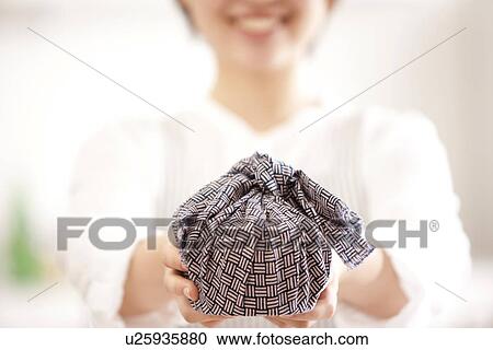 A woman holding a lunch box wrapped View Large Photo Image Stock Image - A woman holding a lunch box wrapped. Fotosearch