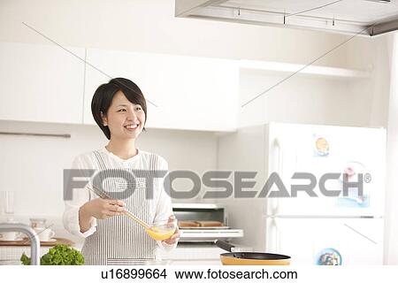 A woman in the kitchen View Large Photo Image Picture - A woman in the kitchen. Fotosearch