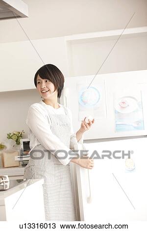 Stock Image - A woman in the kitchen. Fotosearch