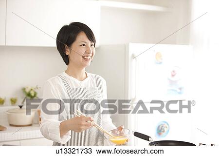 A woman in the kitchen View Large Photo Image Stock Image - A woman in the kitchen. Fotosearch