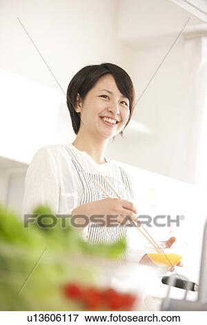 A woman in the kitchen View Large Photo Image Stock Photo - A woman in the kitchen. Fotosearch