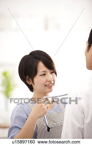 A woman knotting a tie View Large Photo Image Stock Image - A woman knotting a tie. Fotosearch