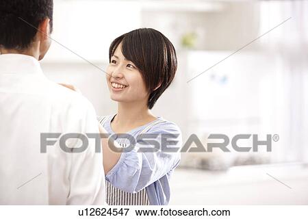 A woman knotting a tie View Large Photo Image Stock Photo - A woman knotting a tie. Fotosearch