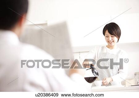 A woman making coffee View Large Photo Image Stock Photo - A woman making coffee. Fotosearch
