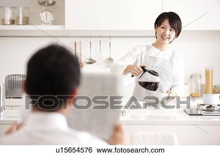 Stock Photograph - A woman making coffee. Fotosearch