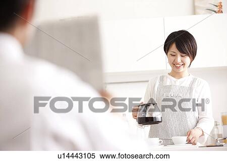 A woman making coffee View Large Photo Image Stock Photography - A woman making coffee. Fotosearch