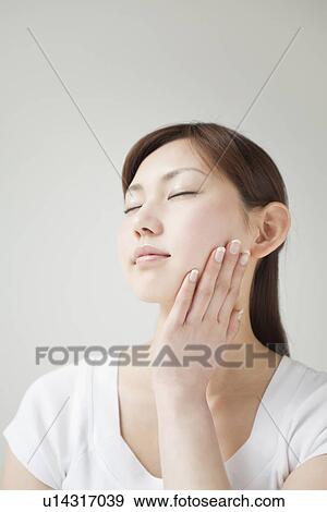 A young woman closing eyes View Large Photo Image Stock Photo - A young woman closing eyes. Fotosearch