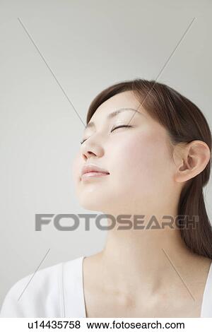 A young woman closing eyes View Large Photo Image Stock Photo - A young woman closing eyes. Fotosearch
