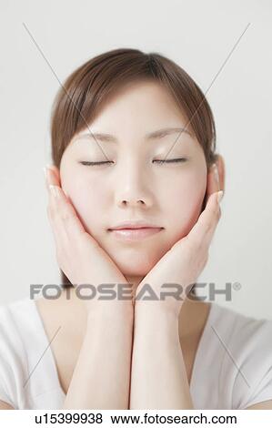 A young woman closing eyes View Large Photo Image Stock Photo - A young woman closing eyes. Fotosearch