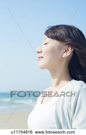 A young woman closing eyes View Large Photo Image Stock Photograph - A young woman closing eyes. Fotosearch