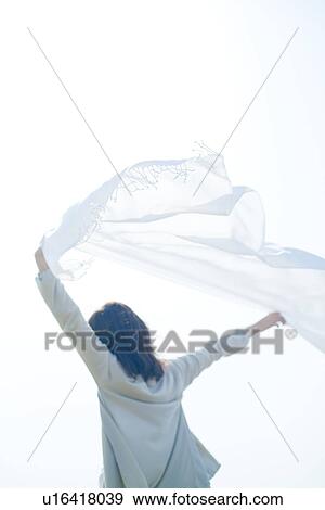 A young woman holding a white cloth View Large Photo Image Stock Photo - A young woman holding a white cloth. Fotosearch