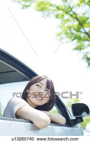 Stock Image - A young woman in a car. Fotosearch