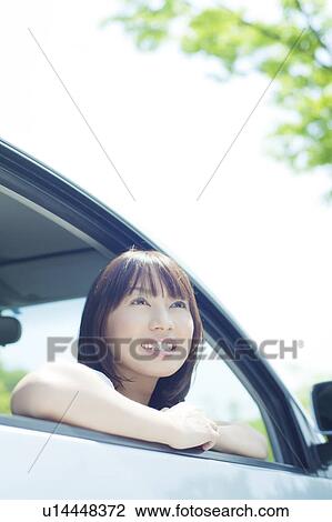Stock Image - A young woman in a car. Fotosearch